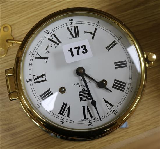 A brass bulkhead clock